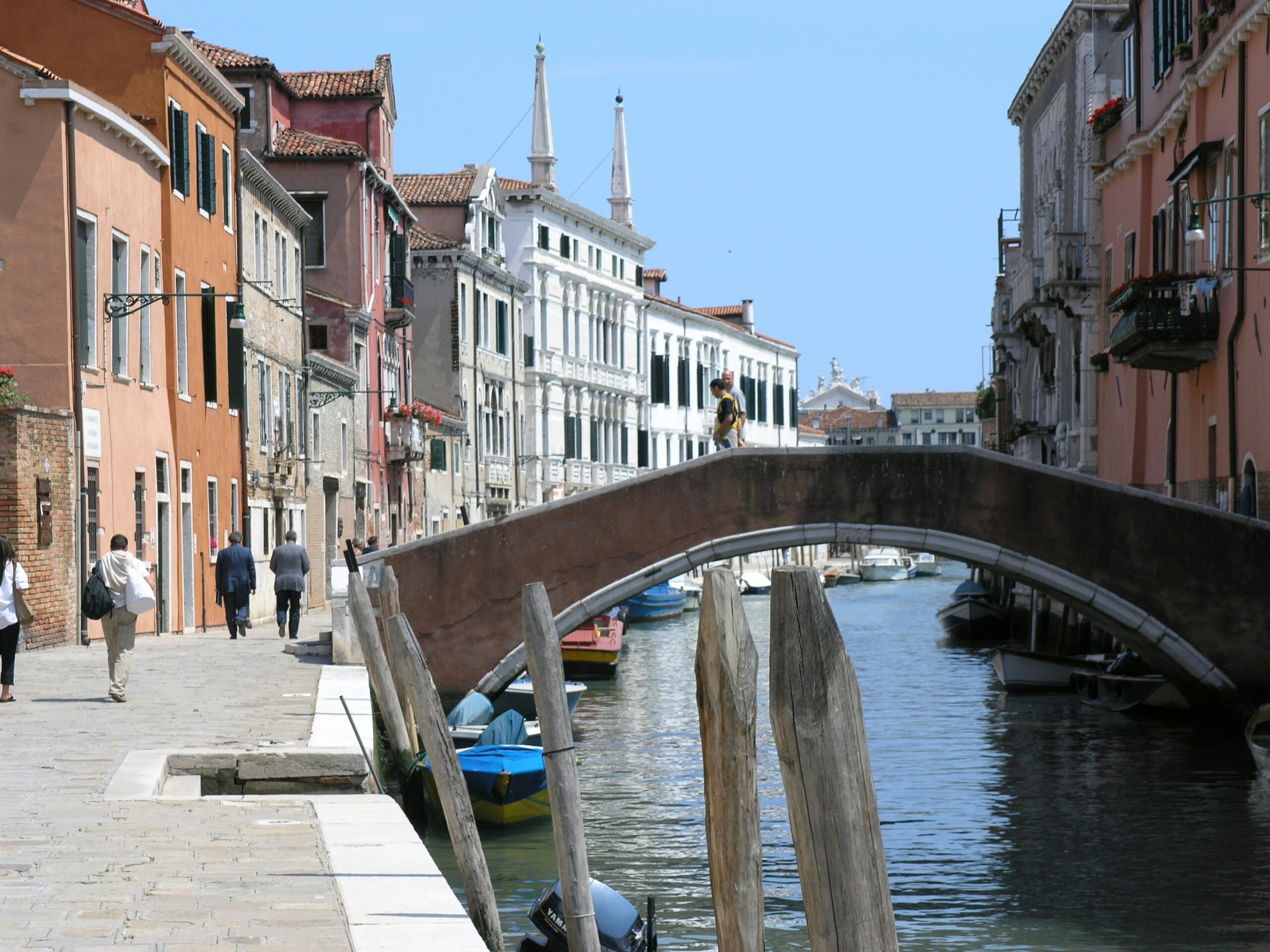 people walking on bridge and near water canal